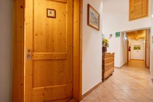 a hallway with a wooden door in a house at Agritur Maso Pan in Caderzone Terme