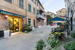 an empty street with a flower shop and buildings at Casa Federico in Levanto