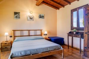 a bedroom with a bed and a window at Vento di Maremma in Marina di Grosseto