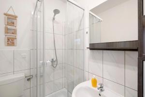 a bathroom with a shower and a toilet and a sink at Ferienwohnung Laage in Laage +11 photos