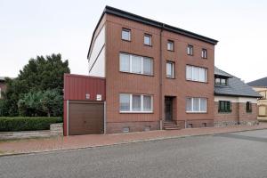 a brick building with a garage on the side of a street at Ferienwohnung Laage in Laage