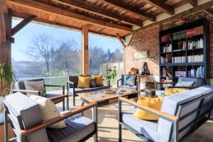 a living room with couches and a book shelf at Cuicui les p'tits oiseaux in Lesperon