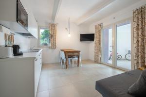 a kitchen with a table and a dining room at Casa Mavi in Corte Franca +12 photos