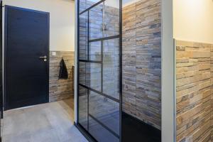 a glass shower door in a bathroom at Cuicui les p'tits oiseaux in Lesperon +16 photos