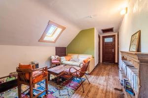 a living room with a couch and a table at Chalet des Bruyères in Saint-Jorioz