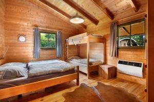 a bedroom with two bunk beds in a log cabin at Pröllerhütte in Grün