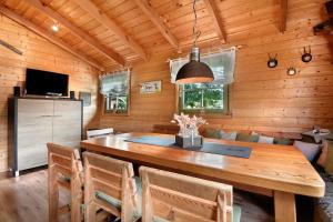 a dining room with a wooden table and chairs at Pröllerhütte in Grün +25 photos