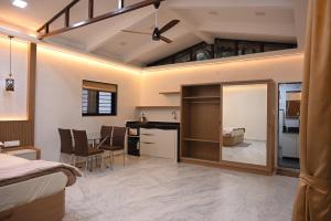 a bedroom with a bed and a kitchen with a mirror at Crystal Water in Mulshi