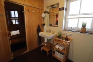 a bathroom with a sink and a window at Villa Sorgenfrei in Zinnowitz