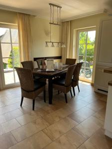 a dining room with a table and chairs at Villa Sorgenfrei in Zinnowitz +22 photos