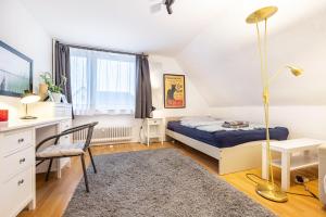 a bedroom with a bed and a desk and a chair at Freundliche Ferienwohnung in Lemgo in Lemgo
