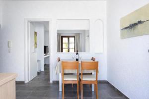 a kitchen and dining room with a table and chairs at Enosis Apartments - Kalypso Beach Flat in Agia Anna Naxos +21 photos