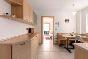 a kitchen with a table and a dining room at Innerjerberhof Sunnseit in Lauregno +22 photos