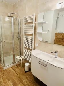 a bathroom with a shower and a sink and a toilet at Residence La Villa Kalliste in Olzano +10 photos