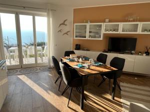 a dining room with a table and some chairs at Residence La Villa Kalliste in Olzano