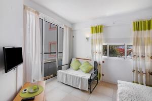 a living room with a couch and a tv in it at Casa Diouma in Cabanas de Tavira +15 photos