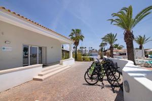 a group of bikes parked next to a house at Casa Diouma in Cabanas de Tavira