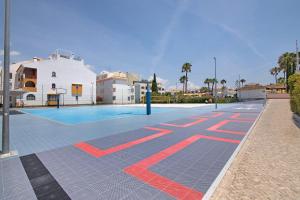 a basketball court in front of a building at Casa Diouma in Cabanas de Tavira