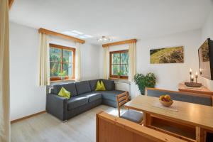 a living room with a couch and a table at Mareiter Stein Blasighof in Racines