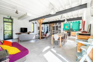 a living room with a couch and a dining room at L'Erdre au moulin in Joué-sur-Erdre +22 photos