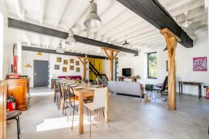 a dining room with a long table and chairs at L'Erdre au moulin in Joué-sur-Erdre