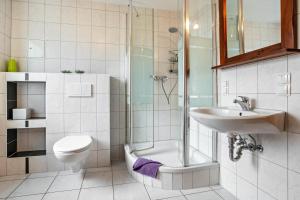 a bathroom with a shower and a sink and a toilet at Feriendomizil Fliedereck in Malchin +126 photos