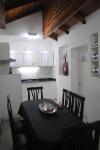 
a dining room table and chairs in a kitchen at First Class Apartments in Córdoba
