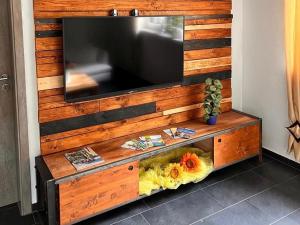 a wooden wall with a tv on top of it at Ferienwohnung Krenz in Uhldingen-Mühlhofen