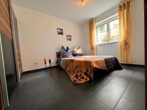 a bedroom with a bed with blue pillows on it at Ferienwohnung Krenz in Uhldingen-Mühlhofen +4 photos