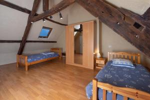 a bedroom with two beds in a attic at Maison Sarzeau Centre - La Bernache in Sarzeau