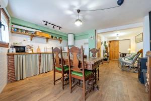 a kitchen with a wooden table and chairs at L'Escambell Grau Del Llop in Ulldemolins +17 photos