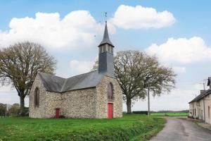 an old stone church with a steeple on a field at Ker Cado - Chambre d'hôtes in Mauron +12 photos