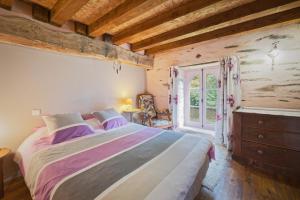 a bedroom with a large bed and a window at Ker Cado - Chambre d'hôtes in Mauron