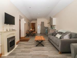 a living room with a couch and a fireplace at Meadow View in Hull