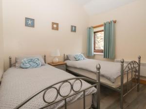 a bedroom with two beds and a window at Meadow View in Hull