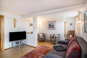 a living room with a couch and a flat screen tv at Haus Moritz in Heimenkirch