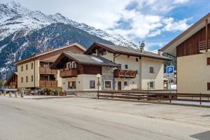 a building on the side of a street with a mountain at Chalet La Fiamma in Santa Caterina Valfurva
