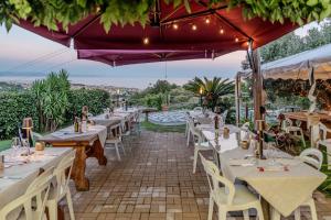 a restaurant with tables and chairs on a patio at Agriotto Agriturismo in Savona