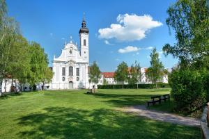 a large white building with a clock tower in a park at Ferienhaus Ludava in Hofmarksgasse
