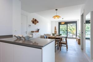 a kitchen and dining room with white walls and a table at Middle Views West in Fuengirola
