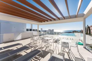 a balcony with tables and chairs and a pool at Middle Views West in Fuengirola