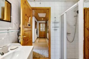a bathroom with a sink and a shower at Ferienhaus Dollrott in Süderbrarup +24 photos