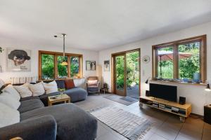 a living room with a couch and a tv at Ferienhaus Dollrott in Süderbrarup