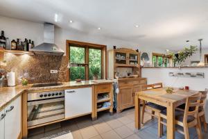 a kitchen with a table and a stove top oven at Ferienhaus Dollrott in Süderbrarup