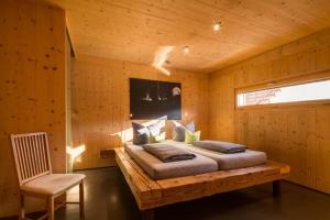 a bedroom with a bed in a wooden room at Ferienwohnungen Winzerhof Keller in Auggen +79 photos