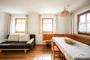 a living room with a table and a couch at Rieplechn App in Sand in Taufers +30 photos