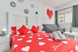 a bedroom with a red bed with white hearts on it at Nerja Boutique 101 Deluxe in Nerja