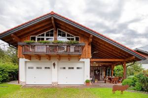 a house with two garage doors and a balcony at Landhaus Exklusive Appartement in Wiederhofen