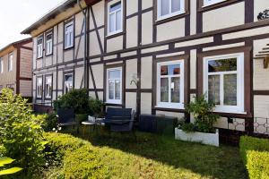 a house with chairs and a table in the yard at Kastanienallee 43 in Ilsenburg