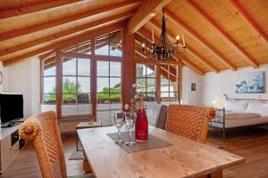 a dining room with a wooden table and chairs at Landhaus Exklusive Appartement in Wiederhofen